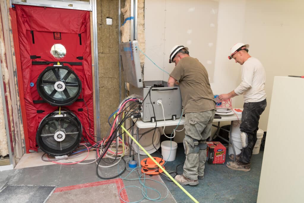 Technicians Operating Aerobarrier & Blower Door