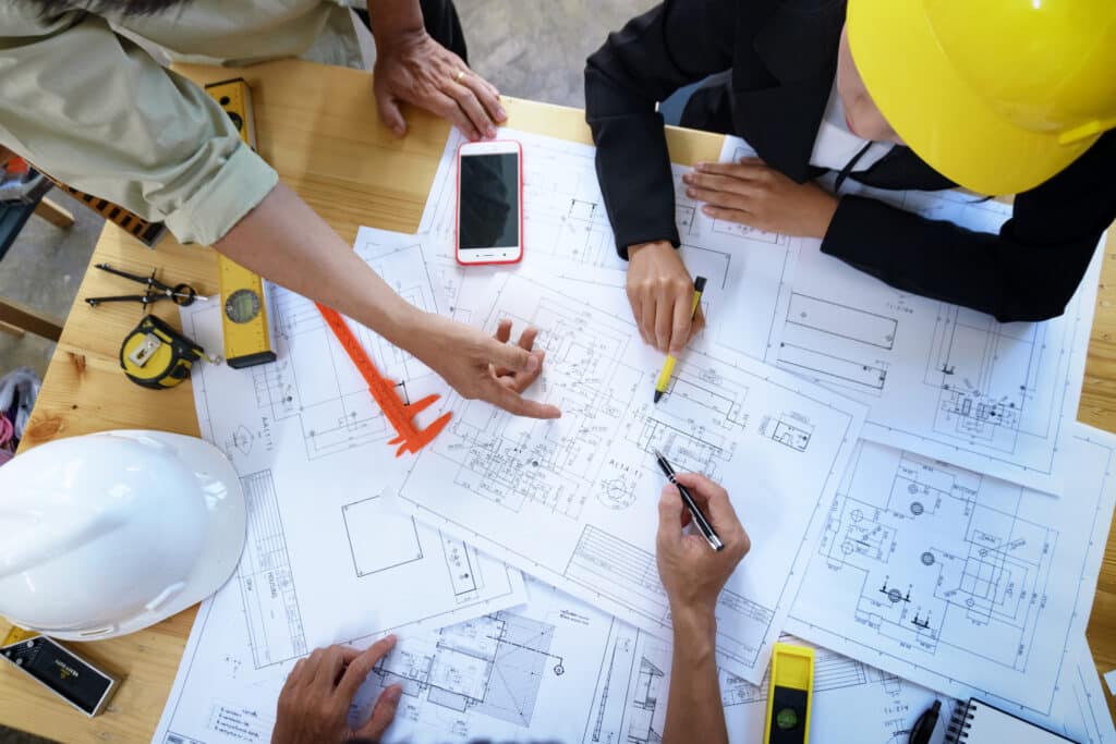 Group of builders reviewing plans for building