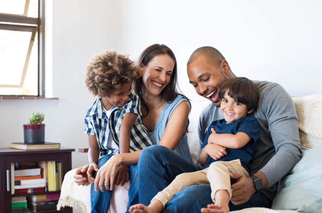 Happy Family Sitting Together On Couch