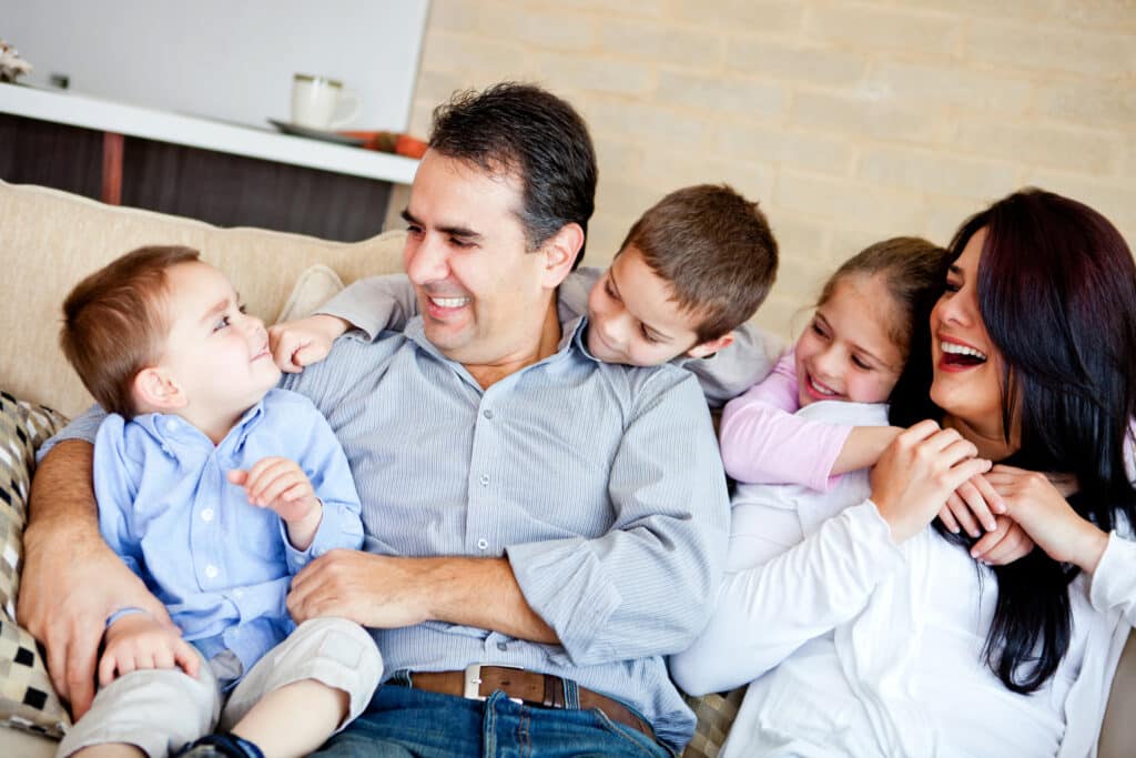 Happy family sitting together on couch